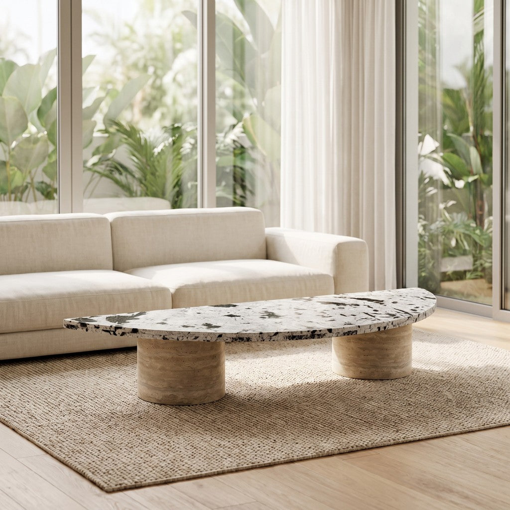 Half-Moon Coffee Table — Speckled Stone Top, Travertine Legs, in a living room