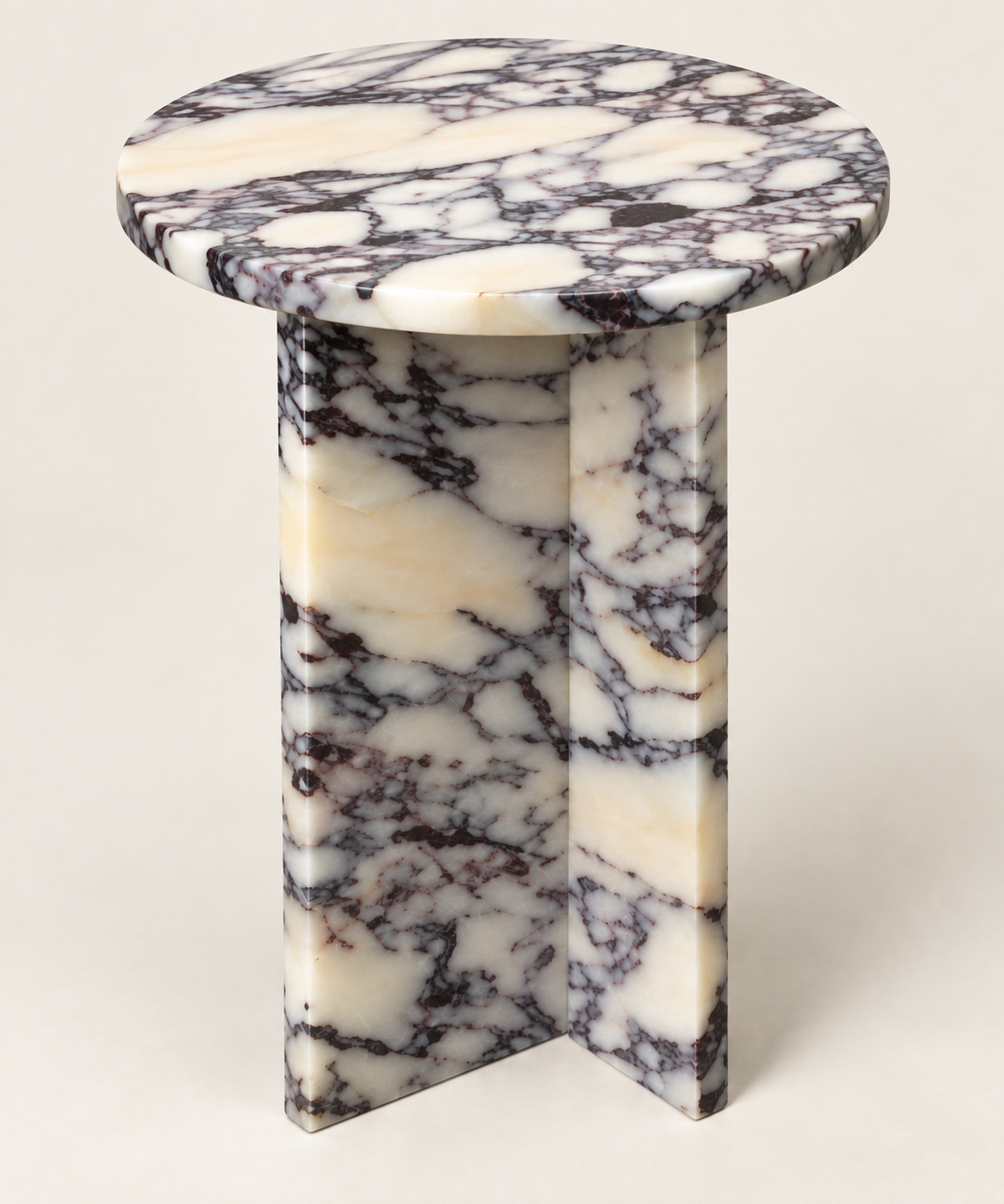 Round T-Base Side Table in Calacatta Viola — elevated structural studio view.