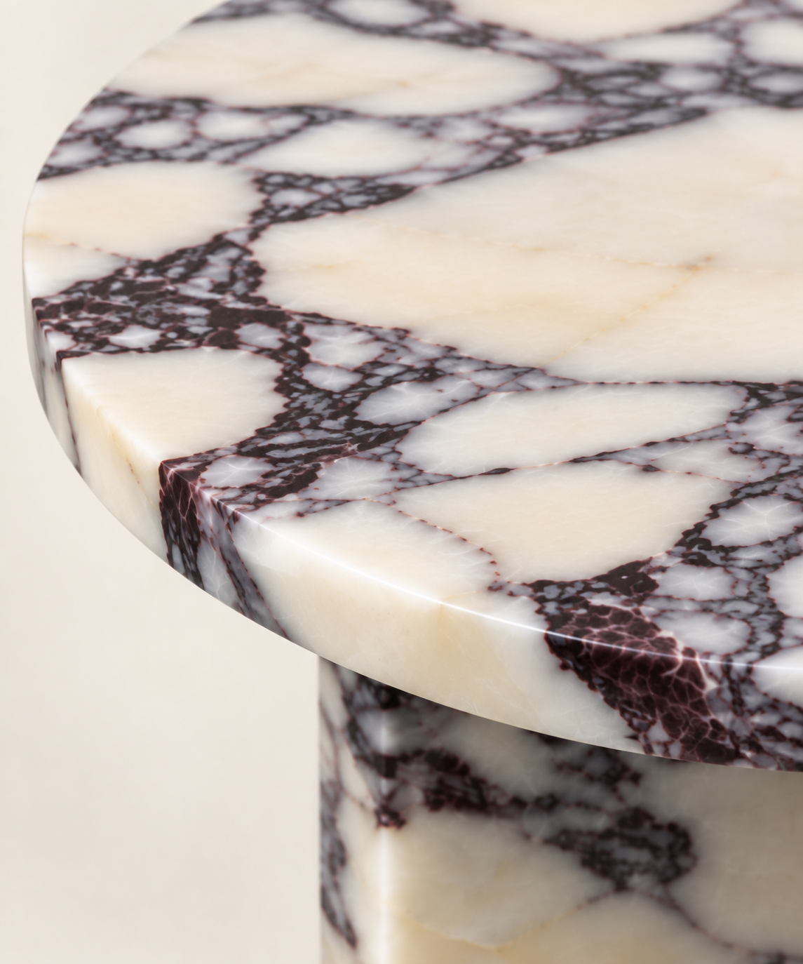 Round T-Base Side Table in Calacatta Viola — marble surface macro detail.
