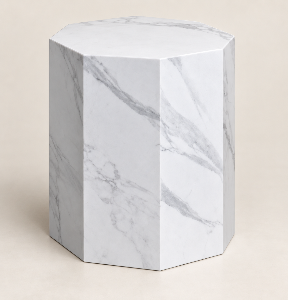 Faceted sintered stone side table in white with grey veining, low three-quarter structural studio view