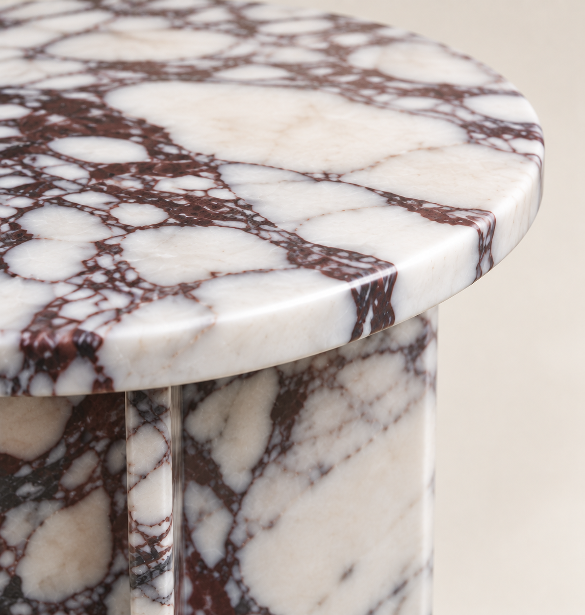 Round Drum Side Table in Calacatta Viola — macro detail of the marble top edge and visible support.
