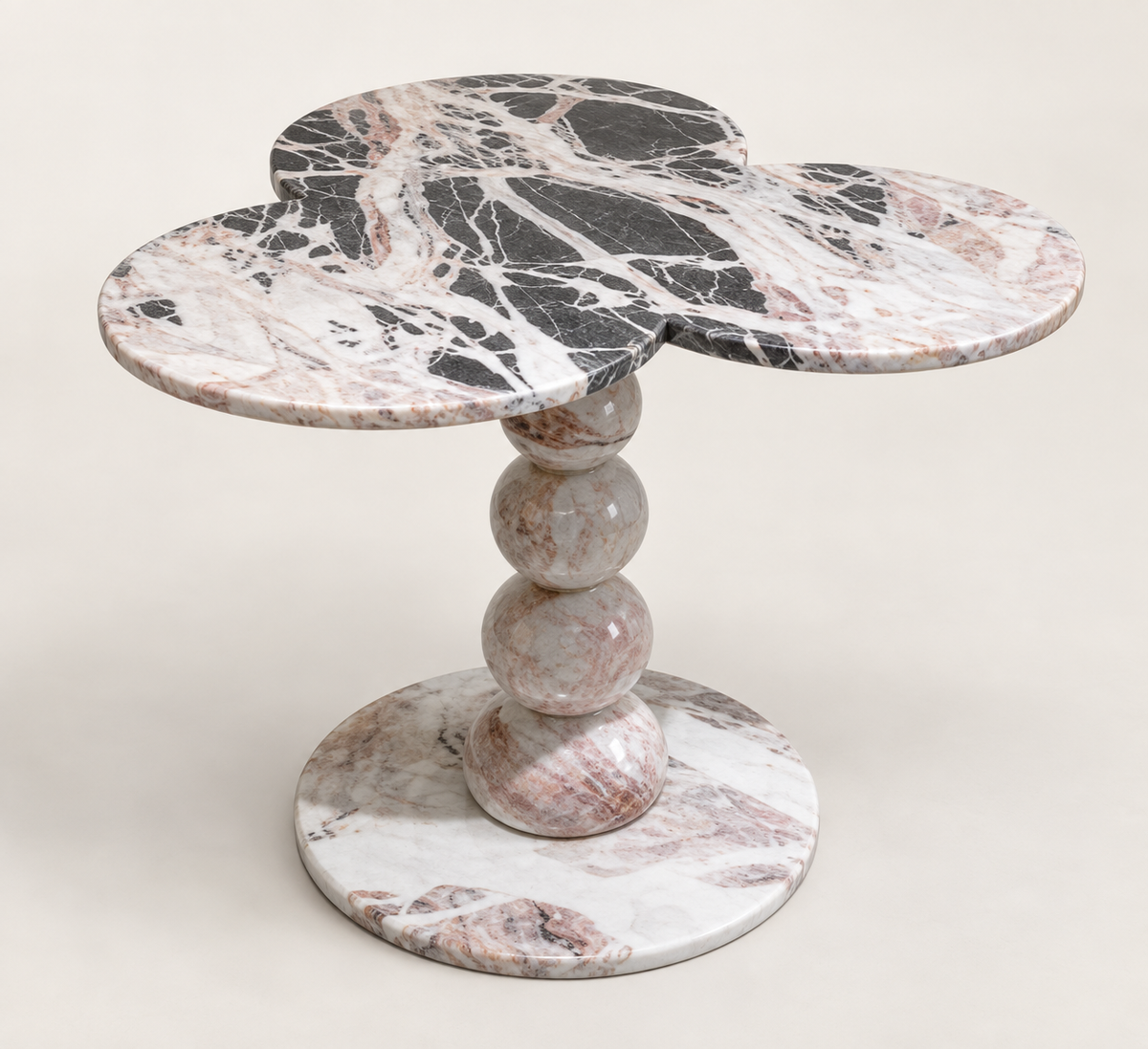 Three-Lobed Pedestal Side Table in grey, black, white and pink natural stone, studio packshot three-quarter view.