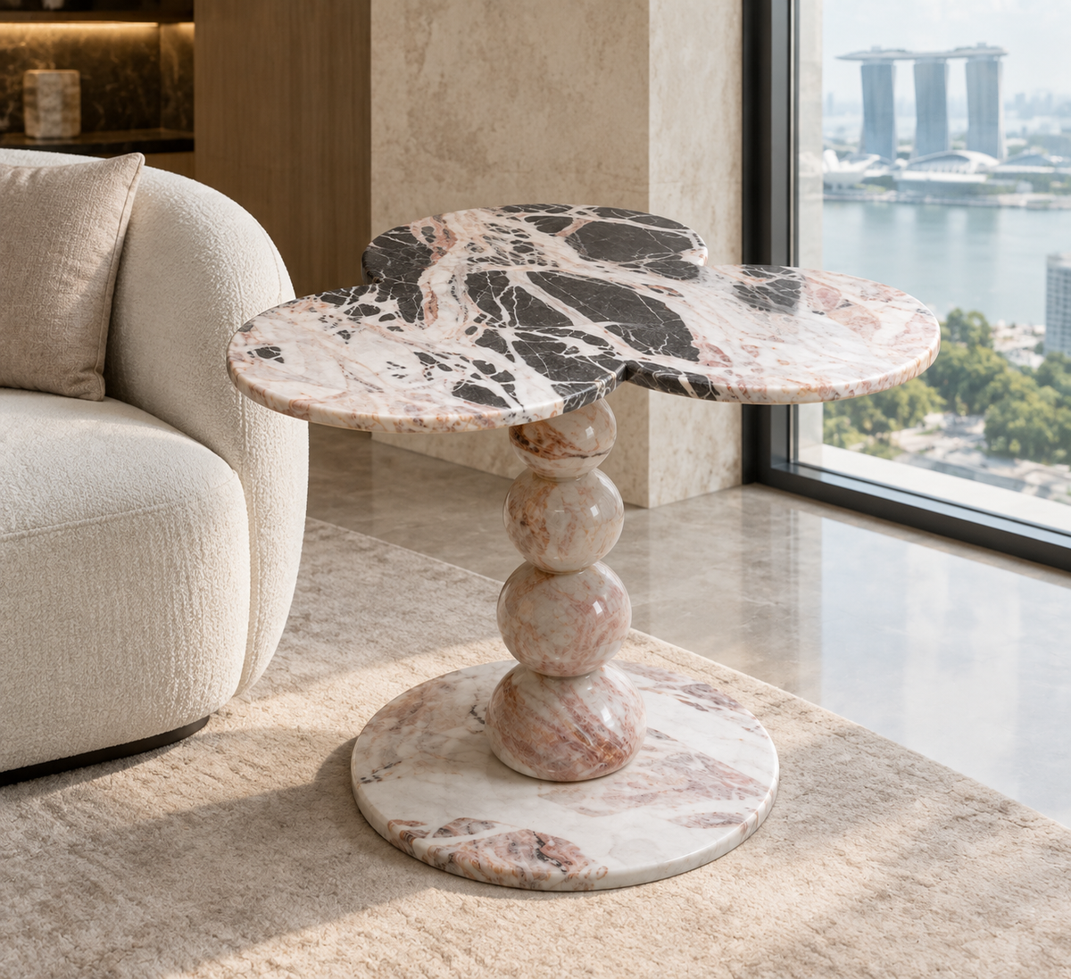 Three-Lobed Pedestal Side Table in grey, black, white and pink natural stone, shown in a premium Singapore interior.