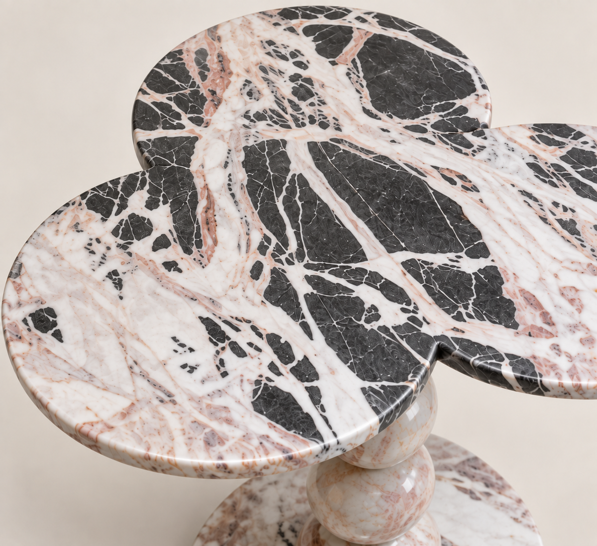Close top detail of the Three-Lobed Pedestal Side Table showing the three-lobed stone surface and polished edge.
