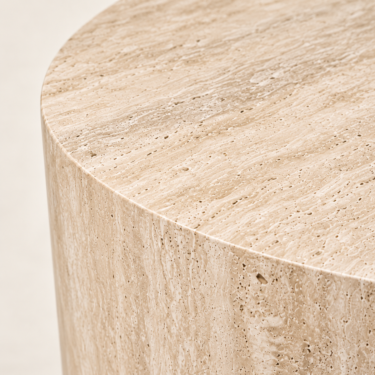 Smooth Drum Travertine Side Table in beige travertine, macro stone texture and top edge detail.