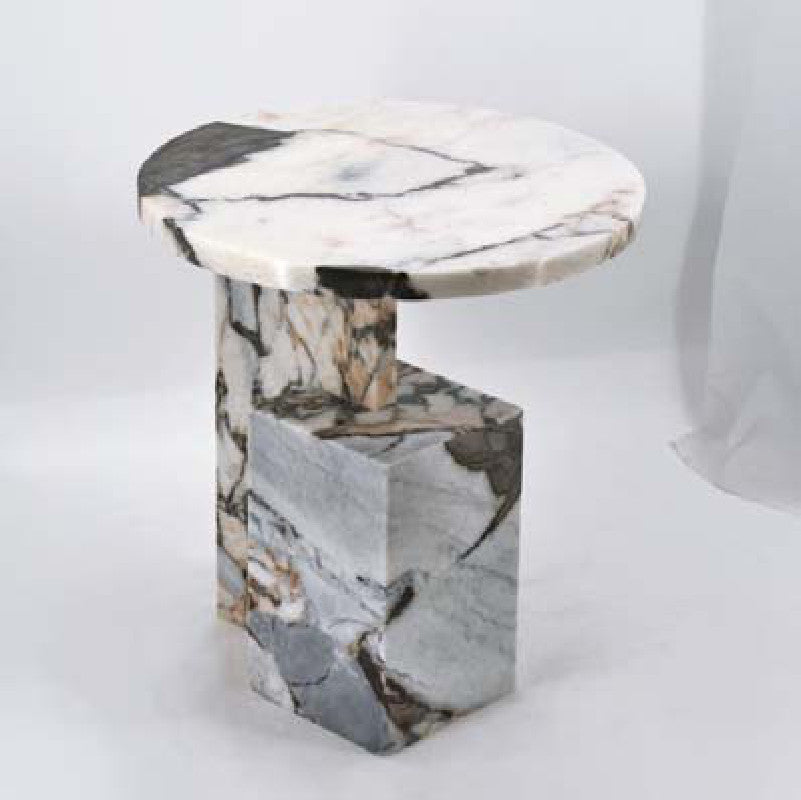 White and grey-veined stone side table with a round top and stepped angular base