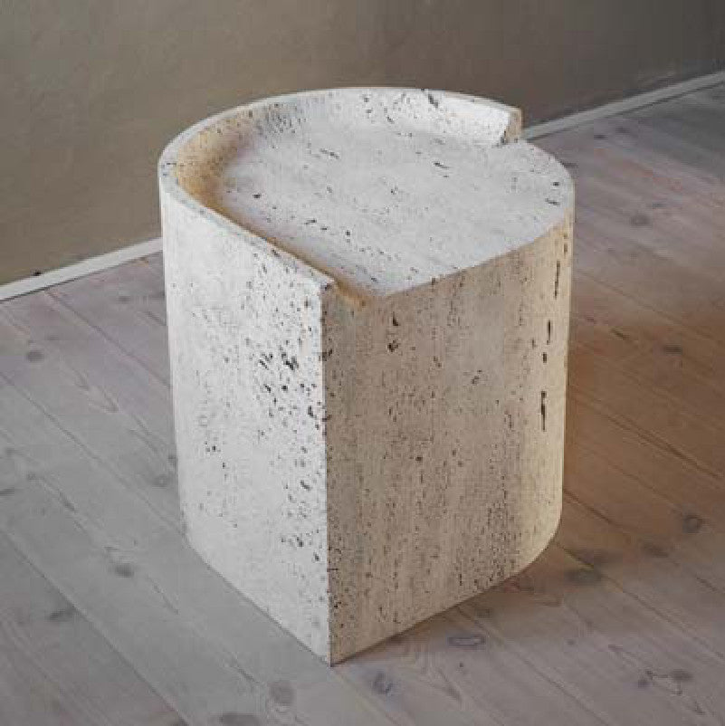Pale textured stone side table with a curved top, stepped notch and solid column base