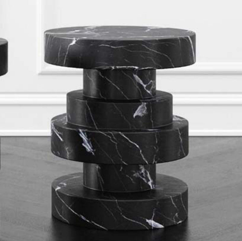 Black and white-veined stone side table with a column of offset stacked circular sections