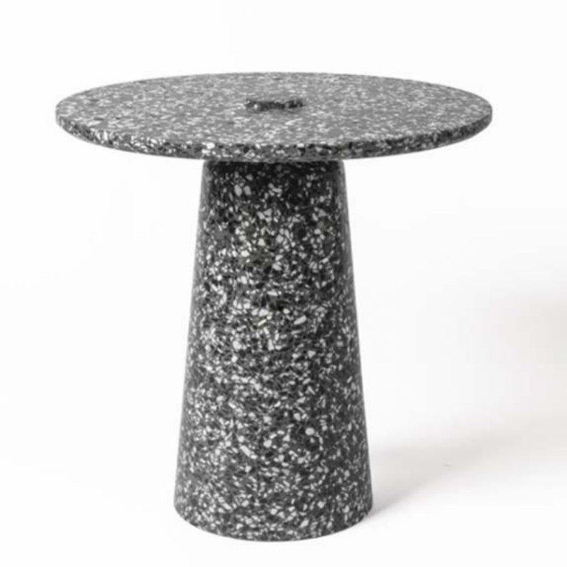 Dark speckled stone side table with a thin round top and tapered cylindrical pedestal