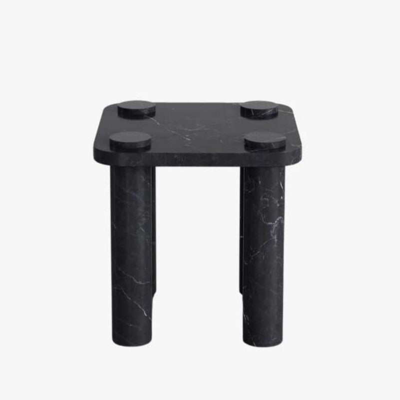 Black veined stone side table with a square top, four cylindrical legs and raised circular details