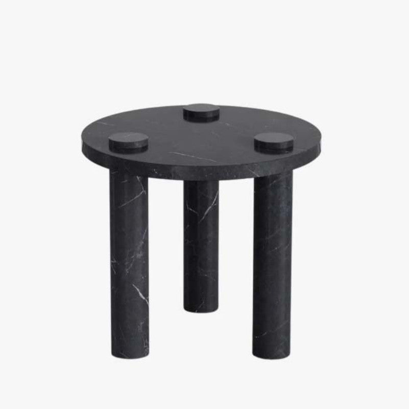 Black veined stone side table with a round top, three cylindrical legs and raised circular details