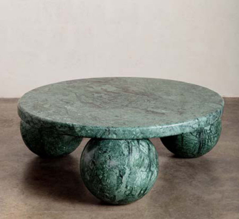 Green patterned stone coffee table with a round top and three rounded ball-shaped supports