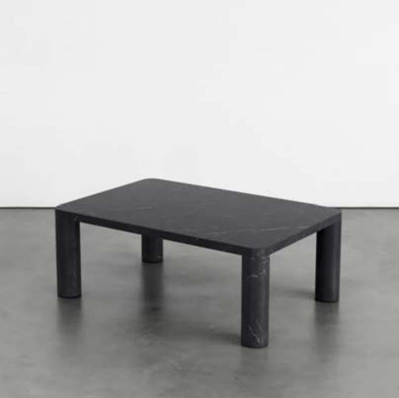 Black veined stone coffee table with a rounded square top and four cylindrical legs