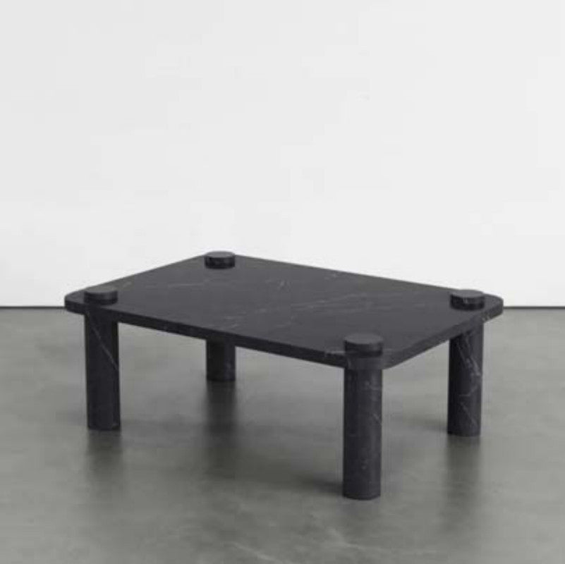 Black veined stone coffee table with a square top, four cylindrical legs and raised circular details