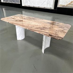Rectangular veined stone dining table with two pale curved supports, three-quarter view