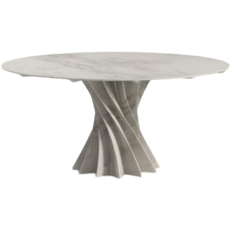 Round pale stone dining table with intersecting curved supports, front view