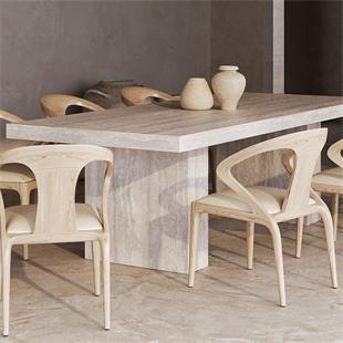 Rectangular stone dining table with slab supports and pale wooden chairs in a dining room