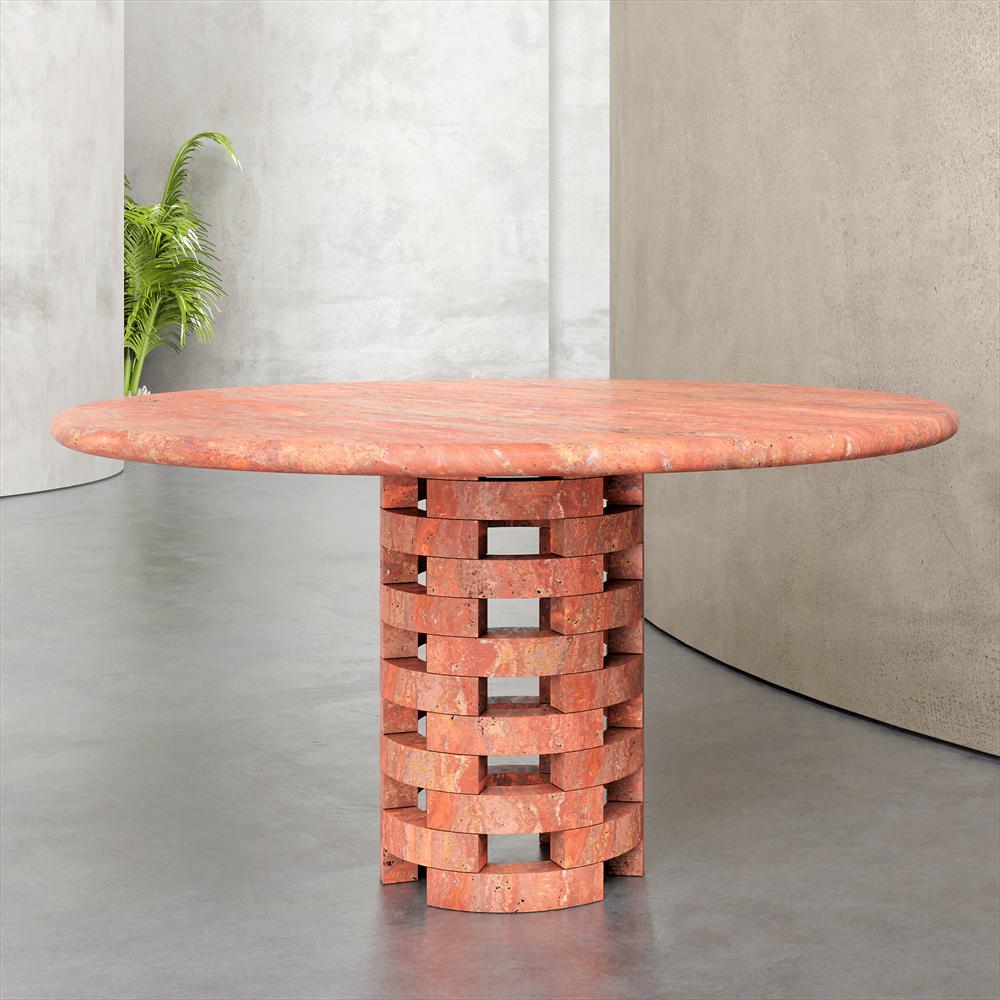 Round reddish stone dining table with an open lattice pedestal, front view