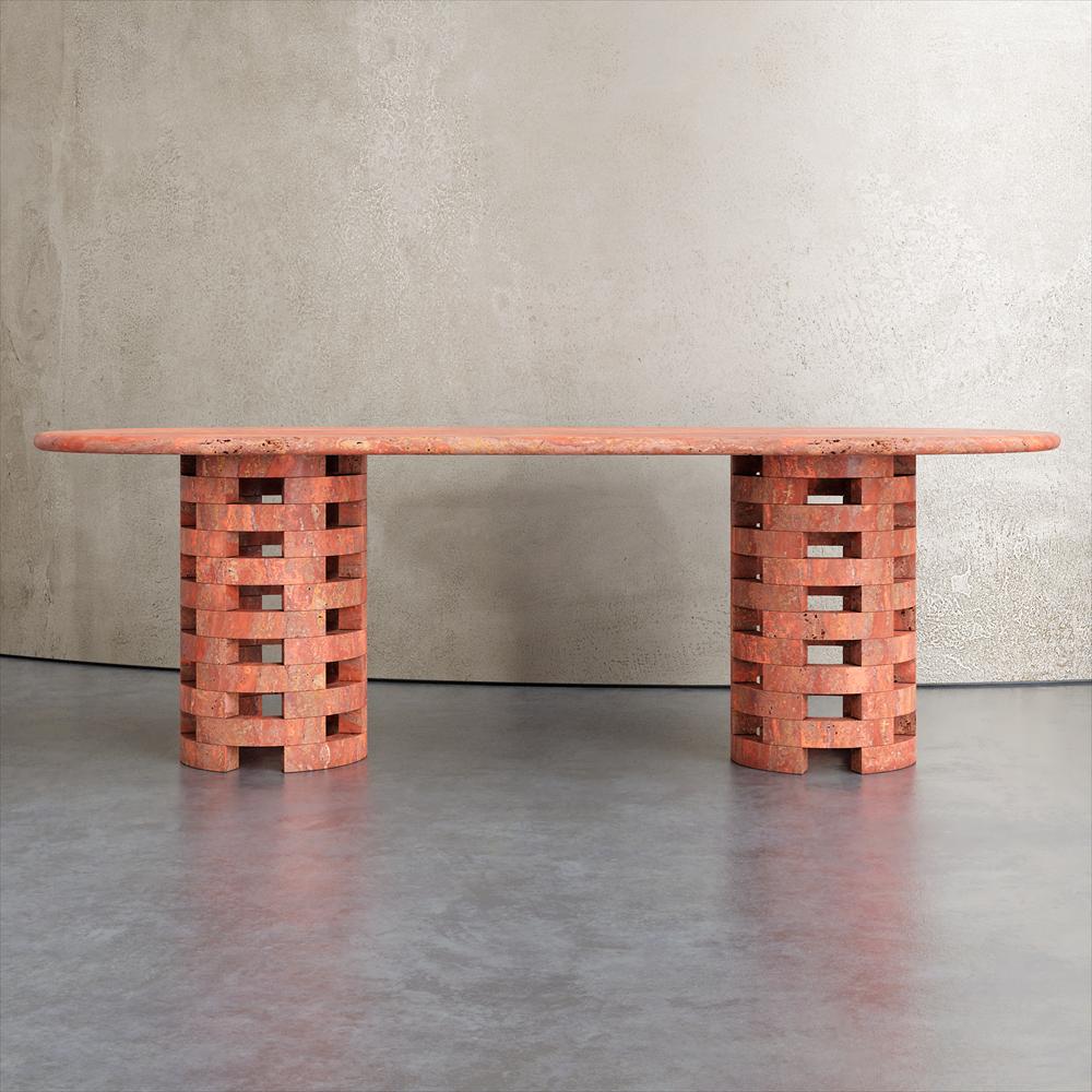 Reddish stone dining table with two open lattice supports, front view