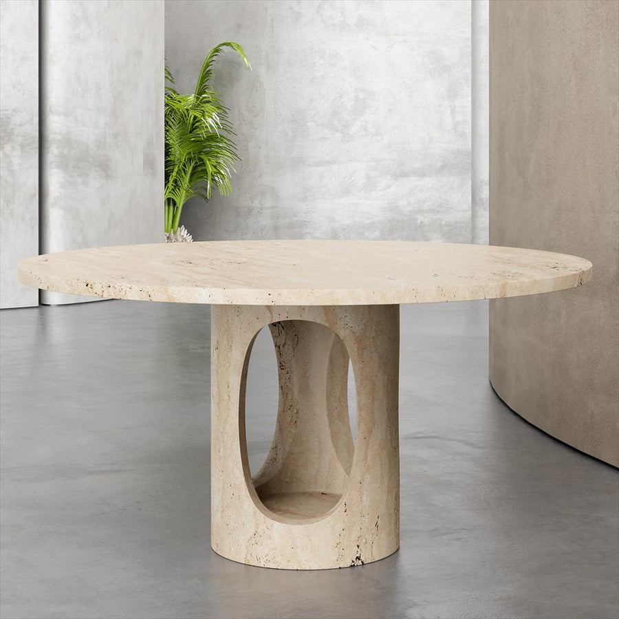 Round pale stone dining table with a cylindrical pedestal and large oval opening, front view