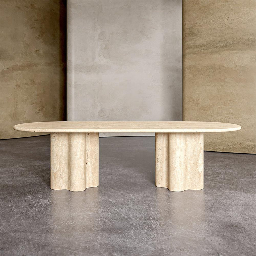 Oval beige stone dining table with two clustered cylindrical supports
