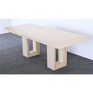 Rectangular pale stone dining table with two open rectangular supports, three-quarter view