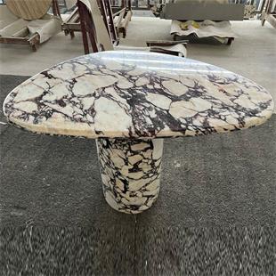 Oval patterned stone dining table with a matching pedestal, viewed from above