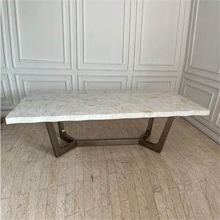 Rectangular pale veined dining tabletop on a dark angular base, front view
