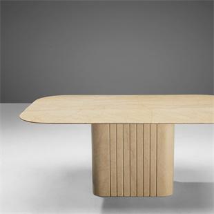 Pale stone dining tabletop with rounded corners and a fluted pedestal, cropped front view