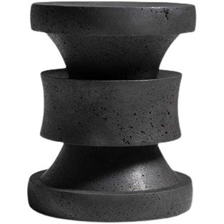 Round dark stone side table with stacked sculptural sections, front view