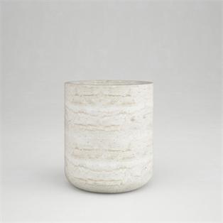 Pale veined cylindrical stone side table with a rounded lower edge against a grey background