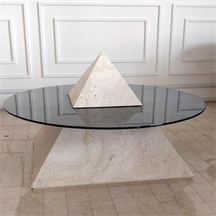 Coffee table with a transparent oval top intersecting a pale stone pyramid base