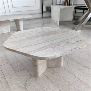 Pale veined stone coffee table with an irregular rounded top and intersecting slab supports