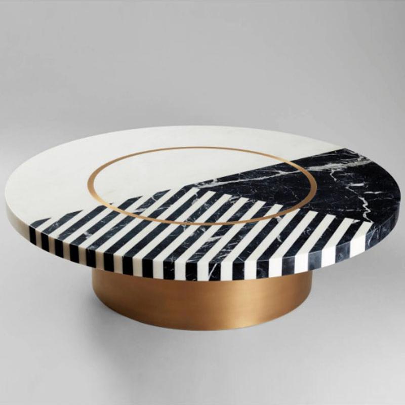 Round black and white patterned coffee table with a gold-coloured circular detail and cylindrical base