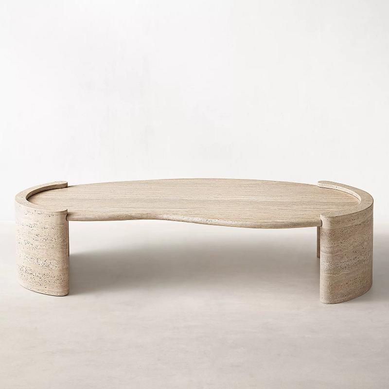 Pale stone coffee table with an undulating top and curved end supports, front view