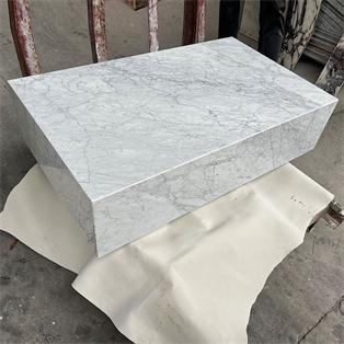 Rectangular pale veined stone plinth coffee table in a workshop, viewed from above