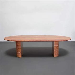Oval reddish stone coffee table with two slab supports, front view