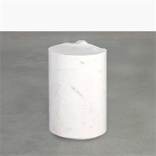Pale stone cylindrical side table with a sculpted uneven top, three-quarter view