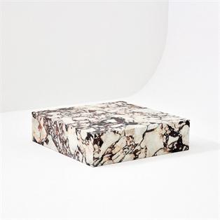 Square strongly veined stone plinth coffee table, three-quarter view