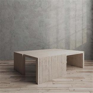Rectangular pale stone coffee table with fluted slab supports, three-quarter view