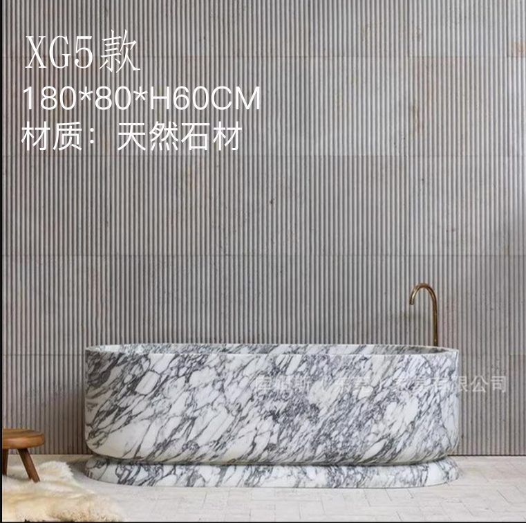 A natural-stone bathtub with a rounded body on a recessed-looking base.