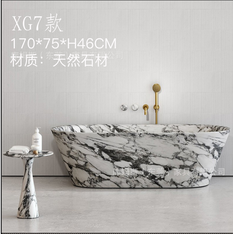 A natural-stone bathtub with a tapered elongated oval body.