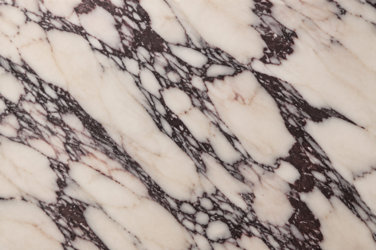 Calacatta Viola marble macro detail with ivory field and dark grey-burgundy veining.