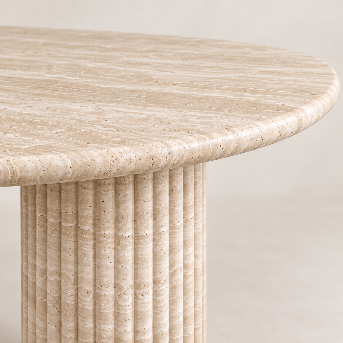 Close-up of the Light Beige Travertine tabletop edge and fluted cylindrical pedestal detail.
