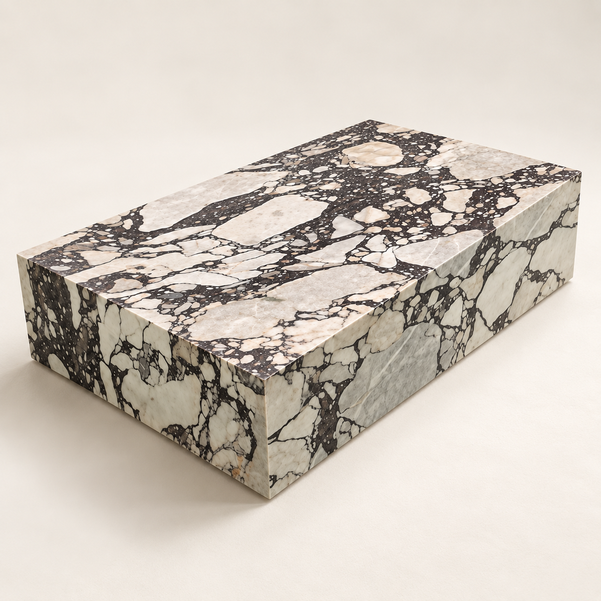 Viola Plinth MS-02 marble coffee table in three-quarter studio view on an ivory background.