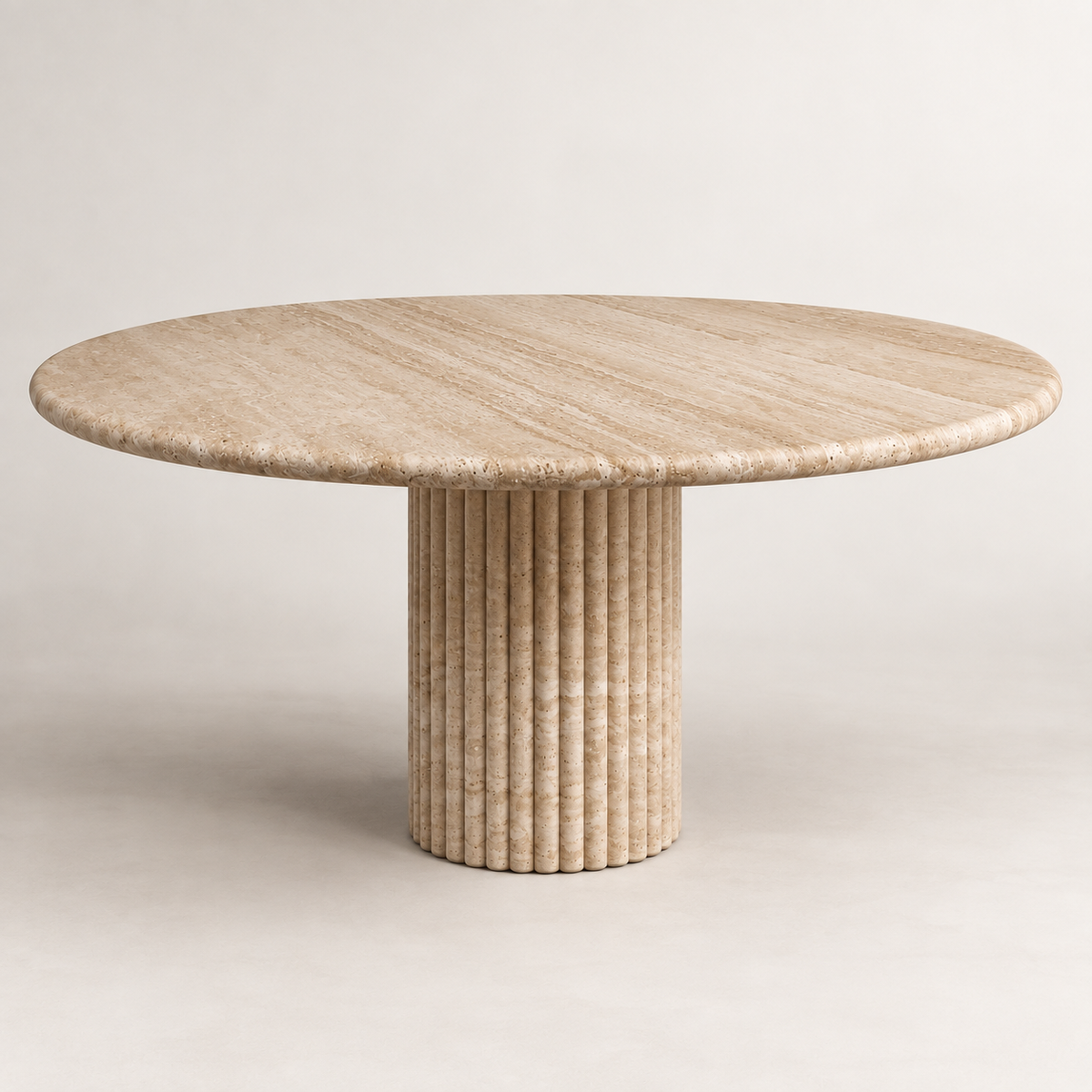 Fluted round light beige travertine dining table, low front studio view