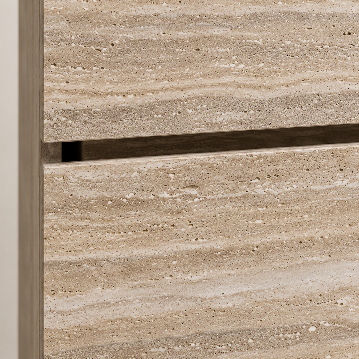 Close-up of light beige travertine grain and recessed horizontal detail on the vanity front.