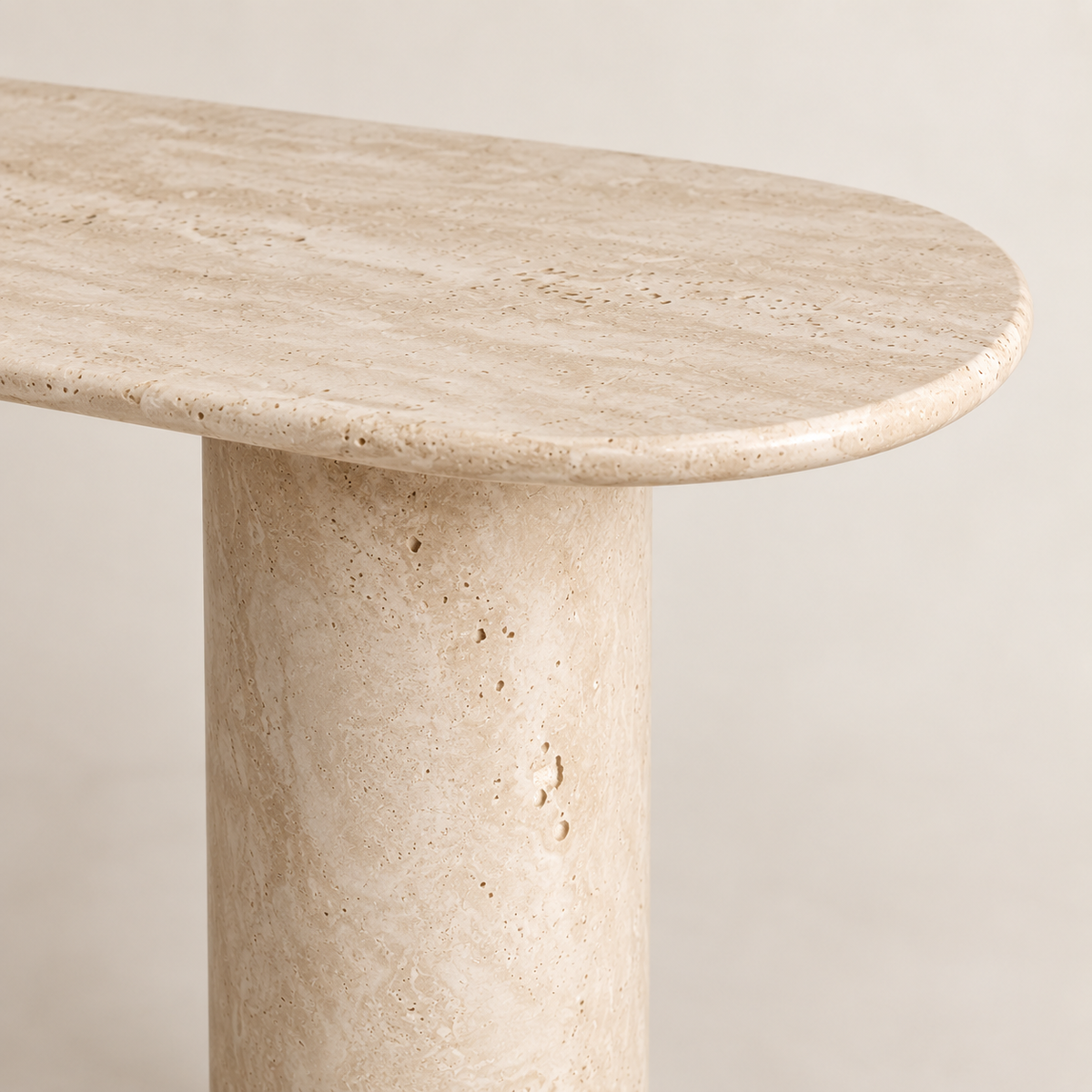 Close-up of the White Beige Travertine Console Table showing the slim rounded tabletop edge, natural stone texture and smooth cylindrical support.
