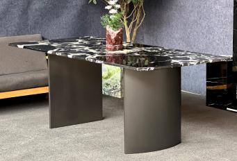 Rectangular Calacatta Black marble dining table with curved dark supports, three-quarter view