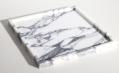 Square white stone tray with dark veining and a raised rim, three-quarter view